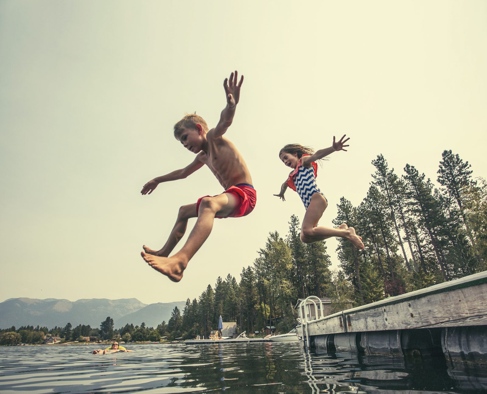 Kids jumping off the dock into the lake — NC/VA Lakes