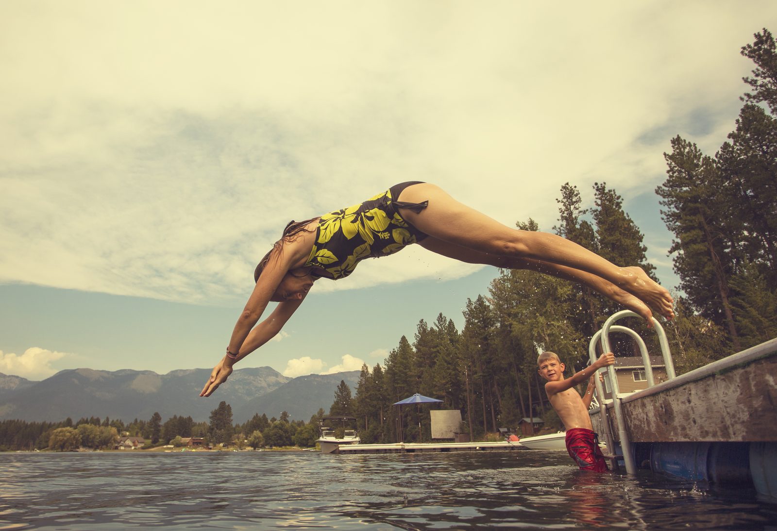 Woman diving off the dock into the lake — NC/VA Lakes